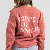 Woman back wearing pink sweater SU1 clothing brand