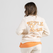 Woman back wearing ecru sweater SU1 clothing brand