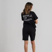Woman back wearing black mid crop tshirt and black shorts SU1 clothing brand