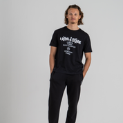 Man wearing black tshirt and black sport trousers SU1 brand clothing