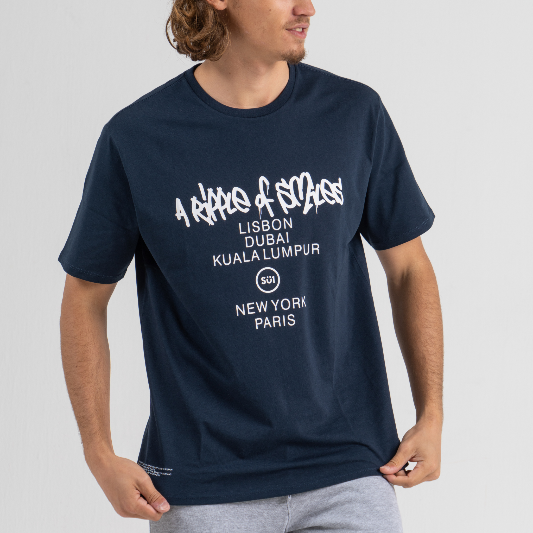 Man wearing dark blue tshirt SU1 brand clothing