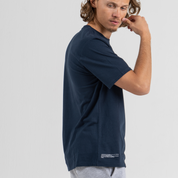 Man wearing dark blue tshirt SU1 brand clothing