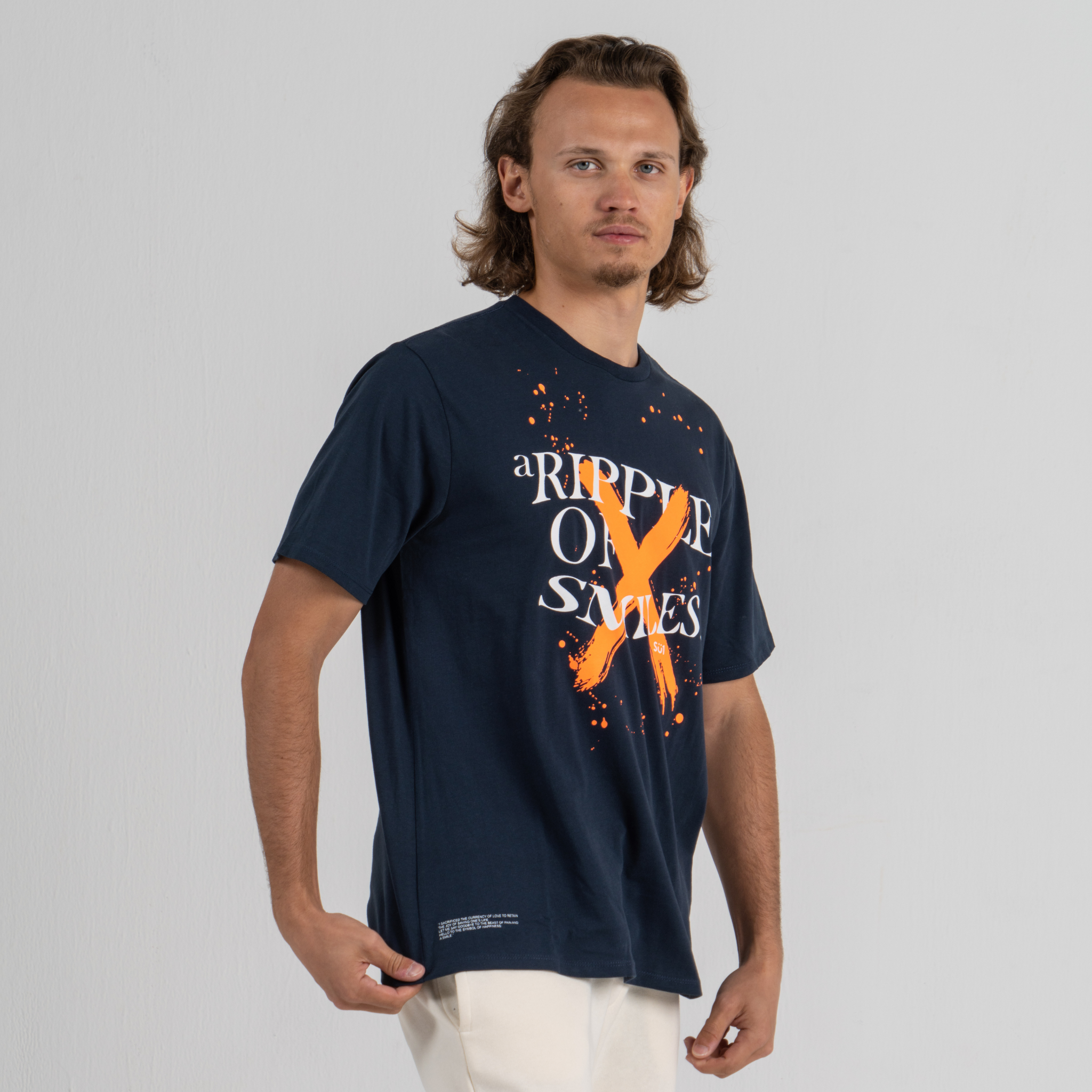 Man wearing dark blue tshirt SU1 brand clothing