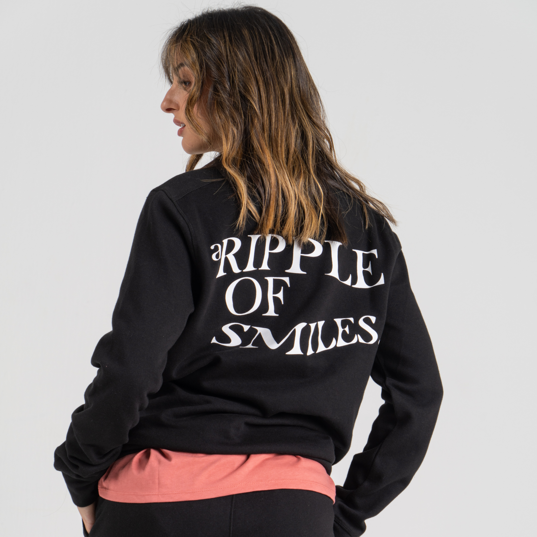 Woman back wearing black sweater SU1 clothing brand 