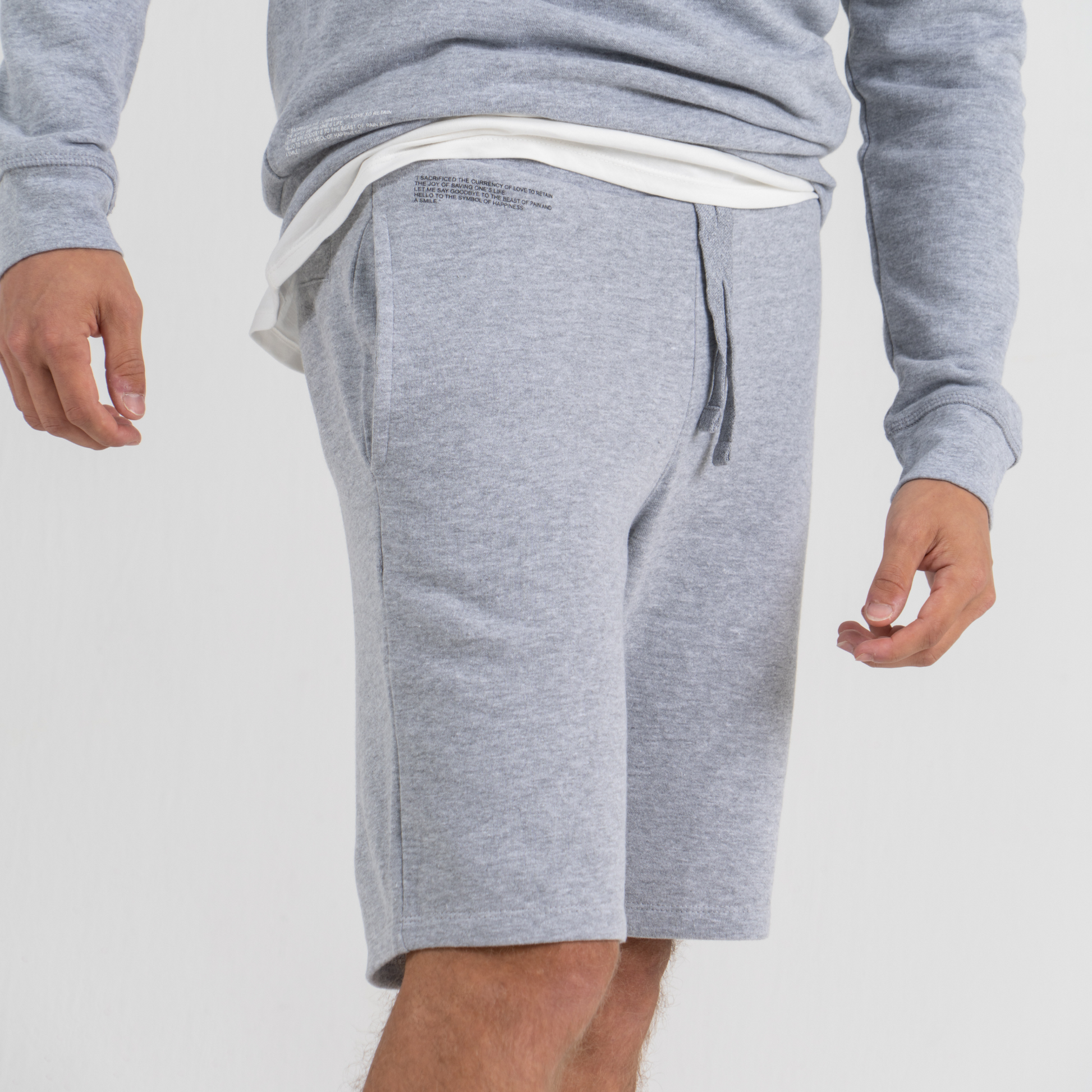 Man wearing grey sport shorts SU1 brand clothing