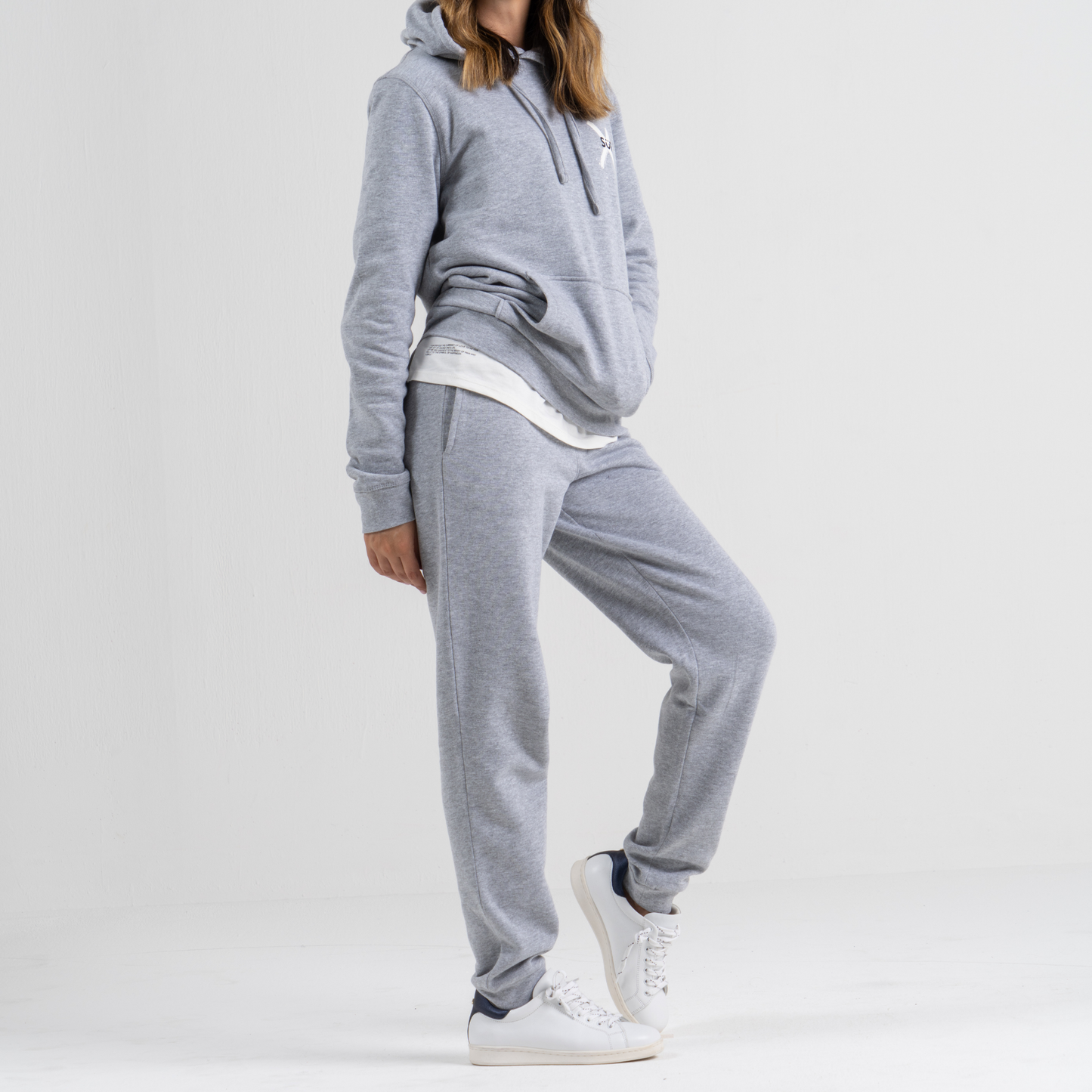 Woman wearing grey sport trousers SU1 clothing brand