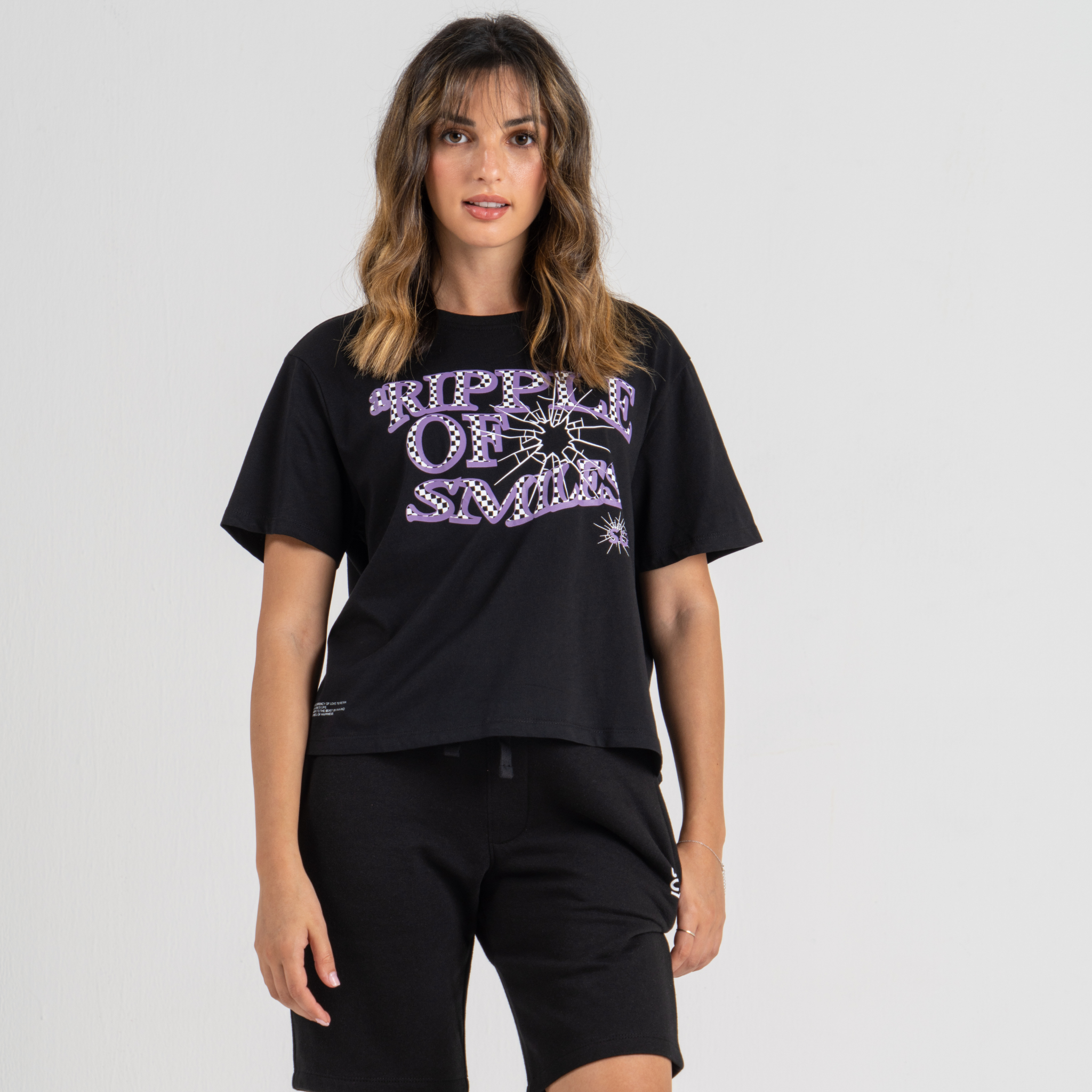 Woman wearing mid crop tshirt black SU1 clothing brand
