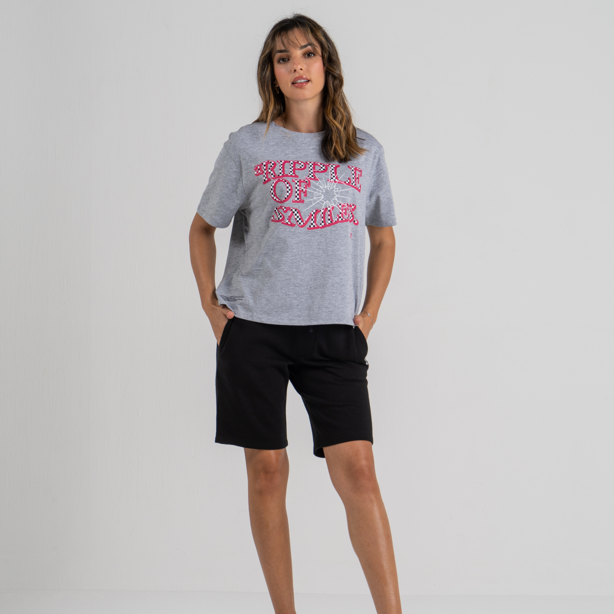Woman wearing mid crop tshirt grey SU1 clothing brand