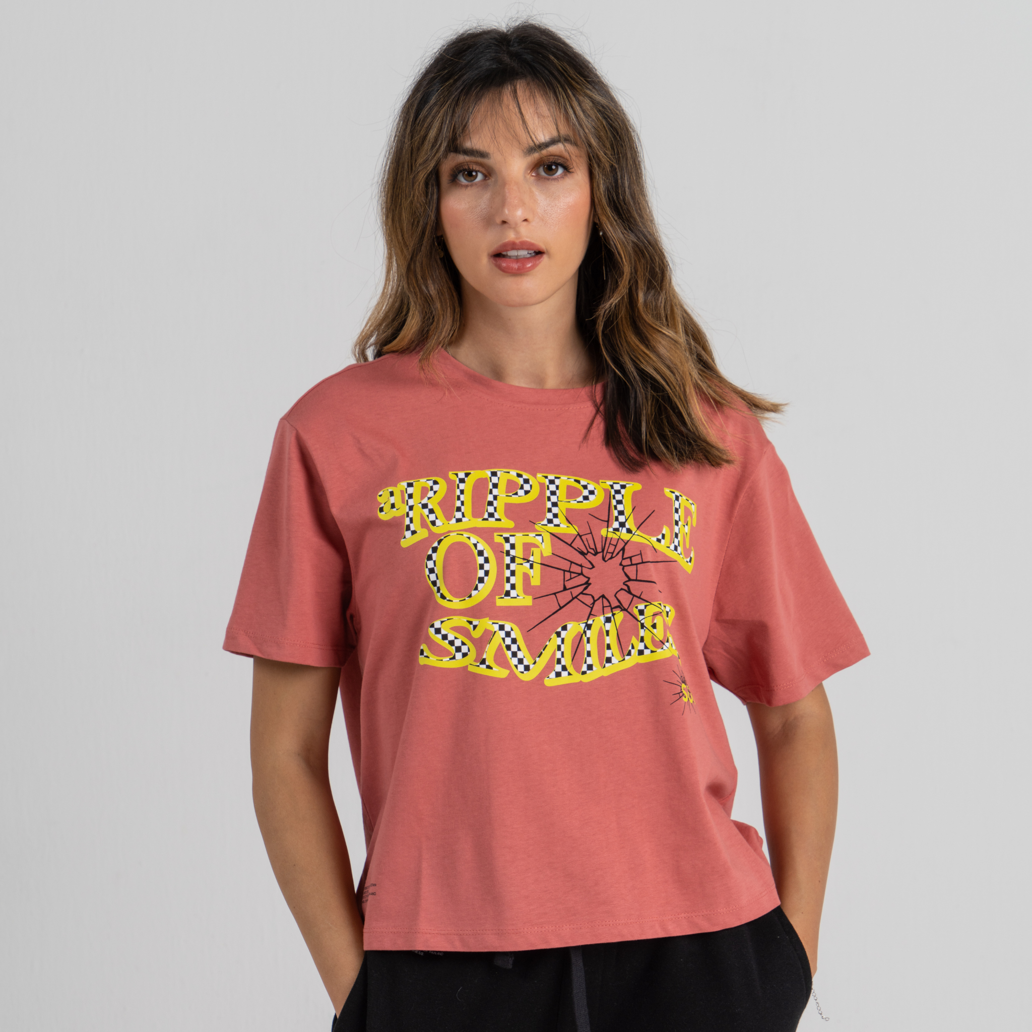 Woman wearing mid crop tshirt pink SU1 clothing brand