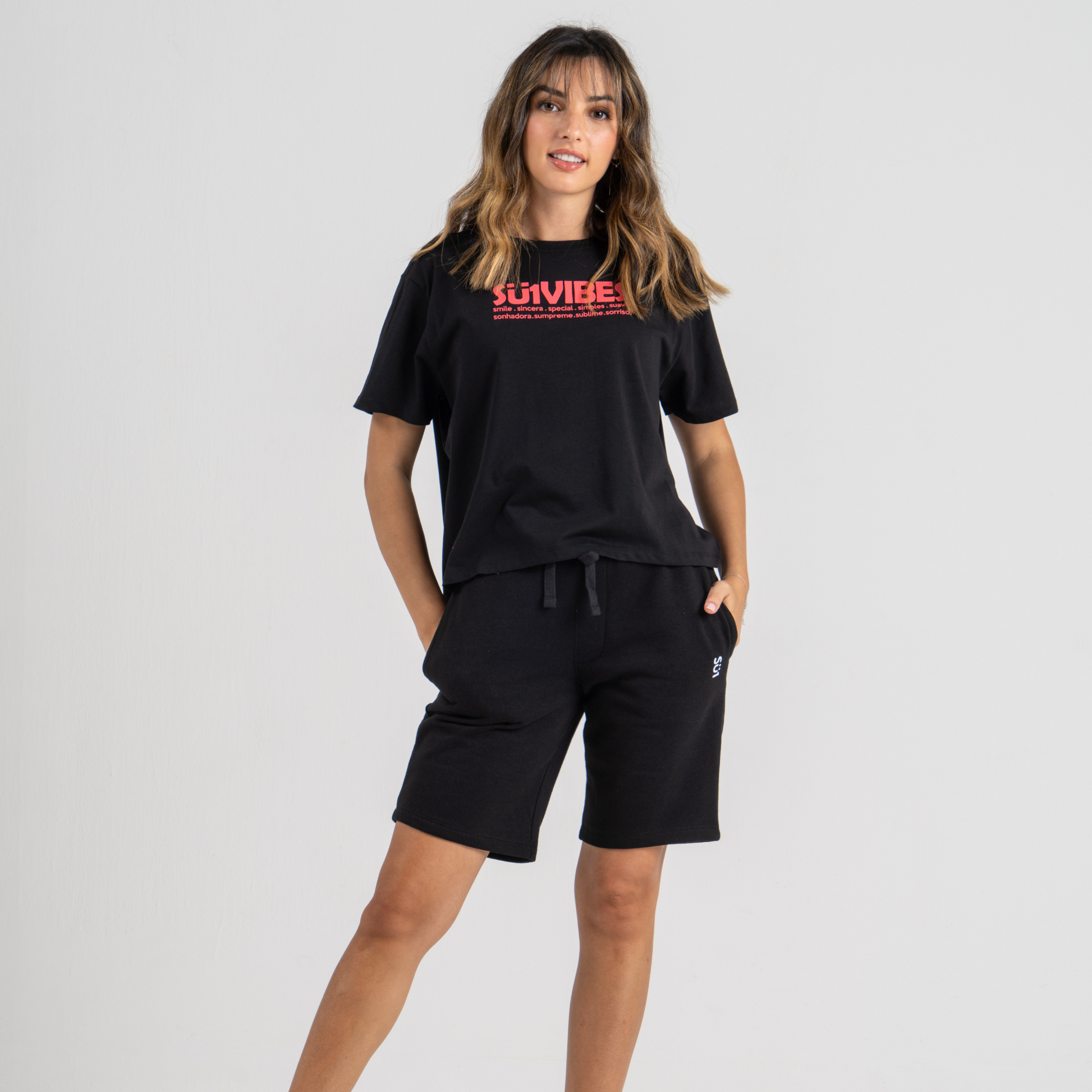 Woman wearing black tshirt mid crop SU1 Brand clothing and black shorts
