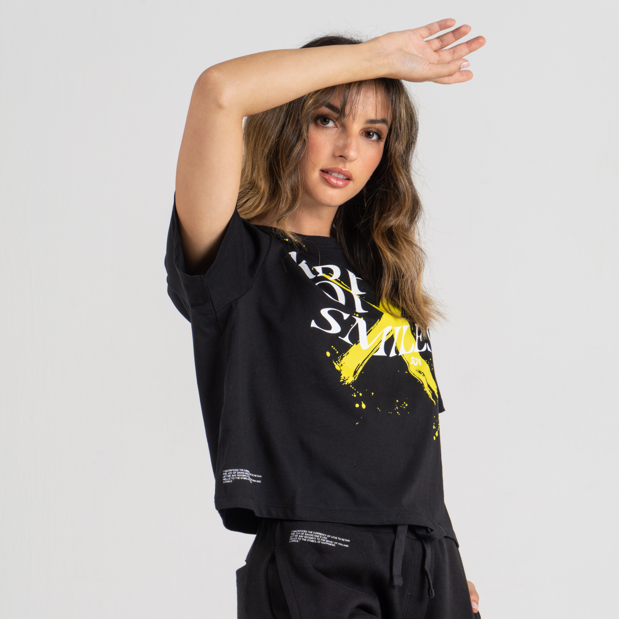 Woman back wearing black tshirt mid crop SU1 clothing brand 