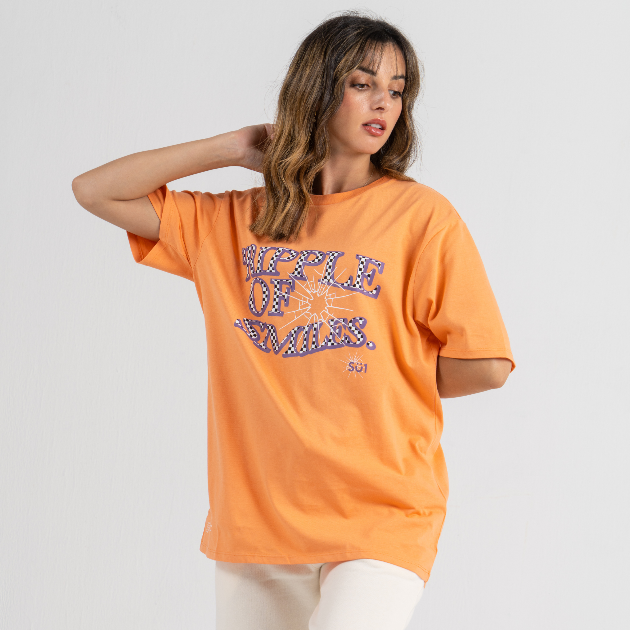 Woman wearing orange tshirt SU1 brand clothing
