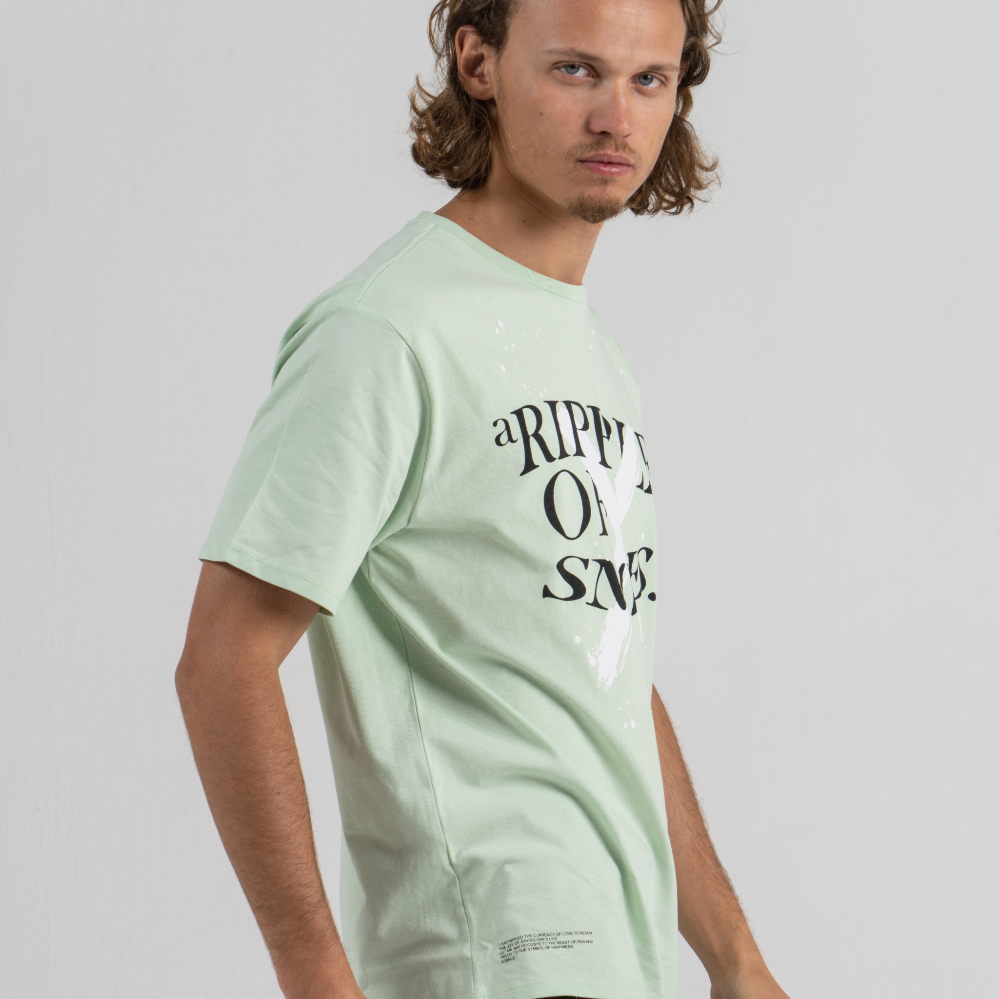 Man wearing mint green tshirt SU1 brand clothing
